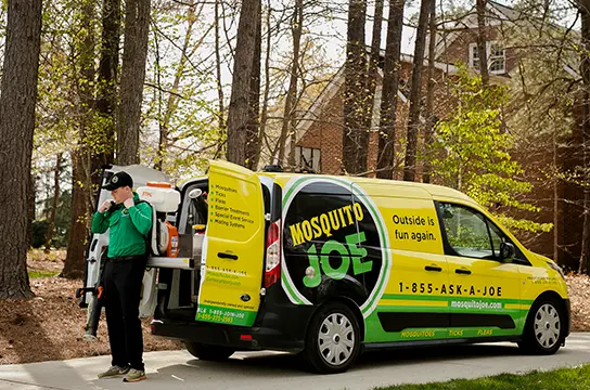 Mosquito Joe professional getting equipment out of company van.